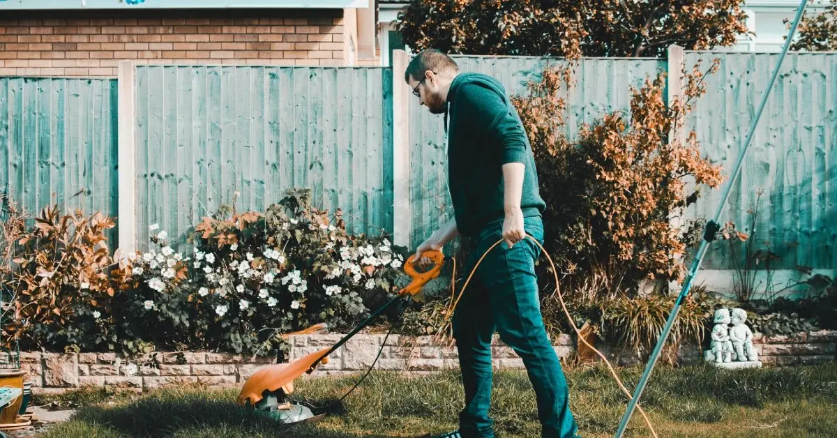 Landscaper mowing a residential lawn